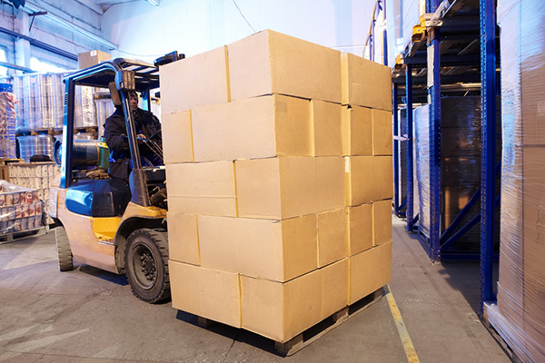 Distribution Warehouse worker moving inventory.